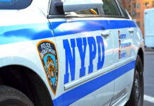 NYPD CRUSHED — 100-Car Gang TAKES OVER… Close-up of a NYPD police car.