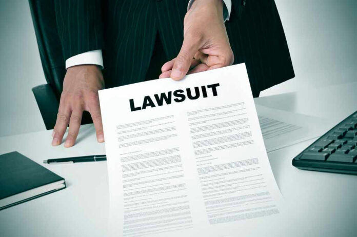 189871757 Holding a document titled Lawsuit in an office.