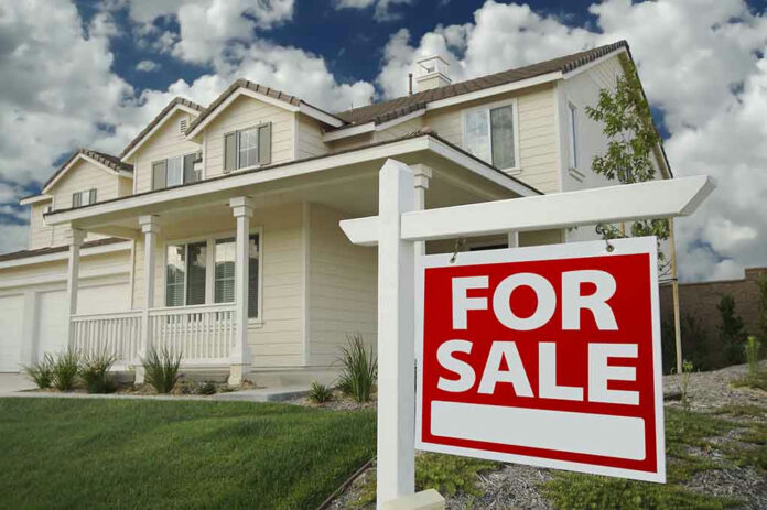 21431701 House with For Sale sign in front yard.