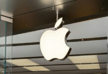 Illuminated Apple logo inside a store.