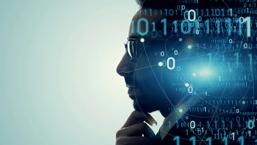Silhouette with binary code and network connections overlay.