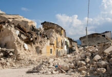 Ancient Christian City Under Fire Rubble from collapsed buildings in earthquake-hit area. Clear sky.