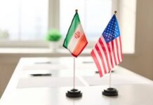 Vance Bets Big On Tehran Mini flags of Iran and the United States on a conference table