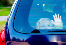 Hot-Car Horror Outside Wingstop Child waving from the back window of car.