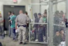 Mexico vs. ICE: Courtroom Showdown Looms People detained behind fencing in a detention center.