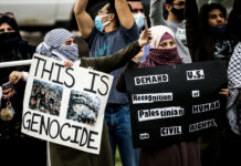 Terror Label Sparks Minnesota Firestorm Protesters holding signs at a rally