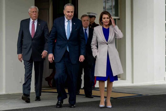 shutterstock_1276349410 Group of suited officials walking out of a government building