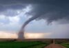 Twin Tornadoes Stun Sweden Tornado touching down over open farmland under dark storm clouds