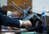 Pentagon Whiplash: Punish Milley, Copy His Move Person pressing a button on a conference microphone panel