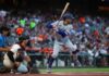 White House Snub Sparks Fresh Fire A baseball player from the Dodgers prepares to bat while the catcher is in position