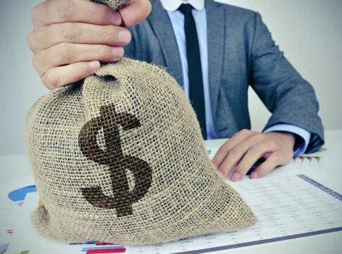 Person holding burlap bag with dollar sign.