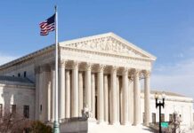 United States Supreme Court building with American flag.