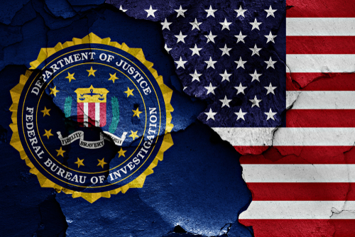 FBI logo beside partially torn American flag background.