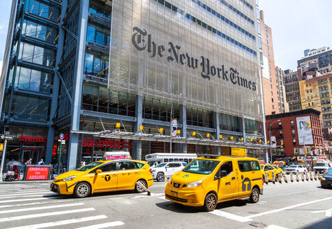 Busy street scene in New York City with yellow taxis and The New York Times building