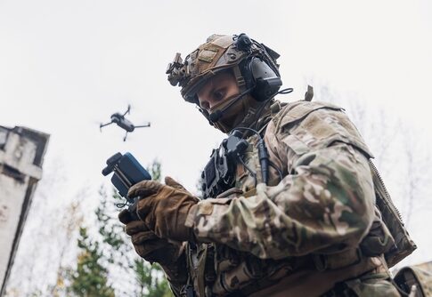 Soldier operating a drone while wearing tactical gear